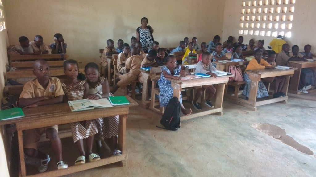 A teacher leading a lesson in a bright classroom